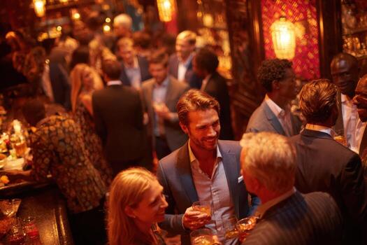 Group of diverse individuals socializing in a vibrant bar atmosphere, enjoying drinks and engaging in lively conversations, showcasing a festive nightlife experience photo