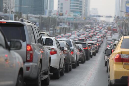 Traffic congestion on a busy urban road, with numerous vehicles lined up in a slow-moving queue, showcasing the challenges of city commuting and transportation dynamics photo