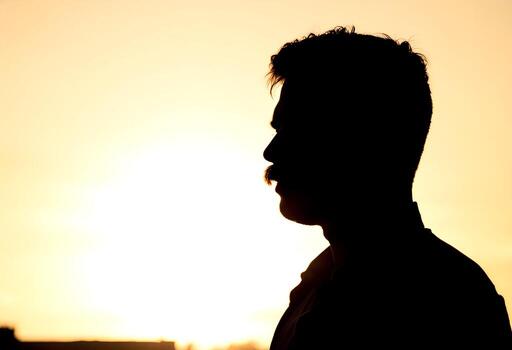 Silhouette of a Man with Mustache at Sunset Dramatic Profile View photo