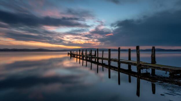 An Enduring Image Of A Pier At Sunset With Long Exposure photo