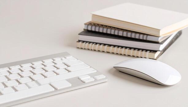 Modern workspace with keyboard, mouse, and notebooks ready for creative work or study sessions now photo