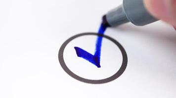 Check mark drawn on paper symbolizing approval, confirmation, success, and completion video