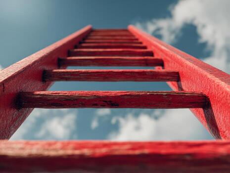 A close-up view of a vibrant red ladder reaching toward a partly cloudy sky, symbolizing aspiration, progress, and the pursuit of higher goals from a low-angle perspective. photo