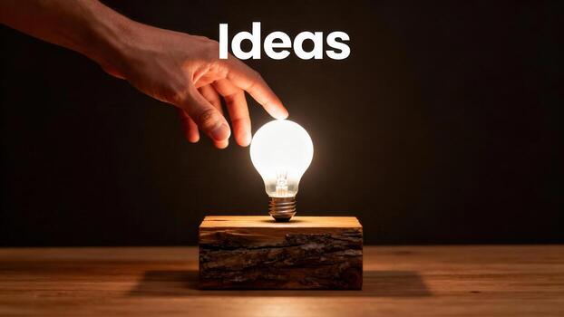 A hand reaching towards a glowing lightbulb, symbolizing new ideas and inspiration. photo