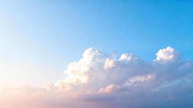 Gentle clouds float across a clear blue sky at dawn. photo