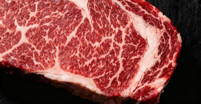 Close-up of a marbled raw beef steak with intricate fat marbling patterns. photo