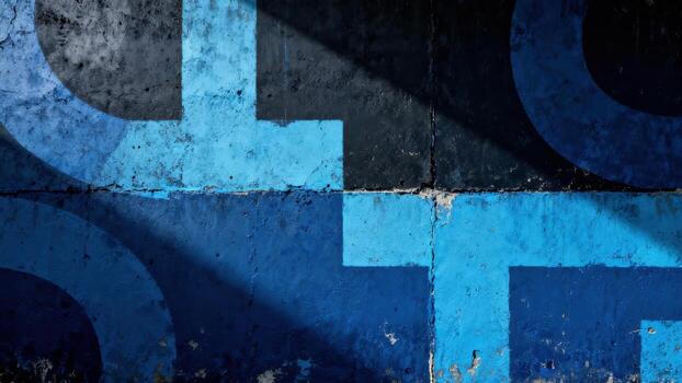 Bold blue geometric shapes are displayed across a textured concrete surface under dramatic shadows. photo