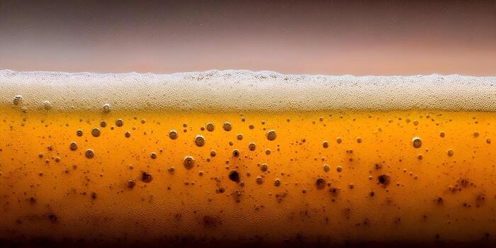 This detailed image captures the vibrant golden color and effervescence of a fresh beer with a thick layer of foam and many bubbles photo
