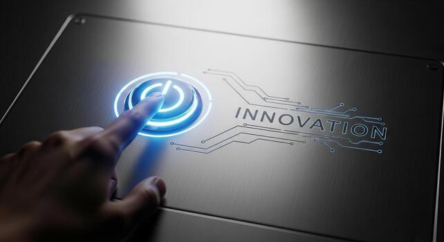 Finger pressing illuminated blue power button with INNOVATION text and circuitry representing the start of a new technological era and creativity photo