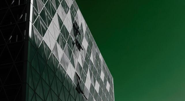 Striking Abstract Modern Architecture Geometric Glass Facade with Triangular Pattern Against a Vibrant Green Background photo