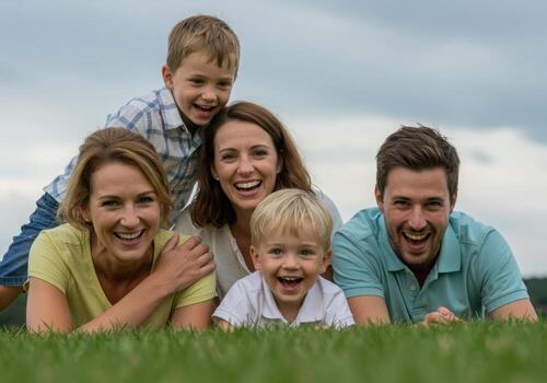A family is smiling in the grass photo
