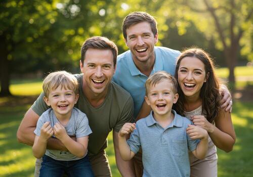 A family of four posing for a picture in the park photo