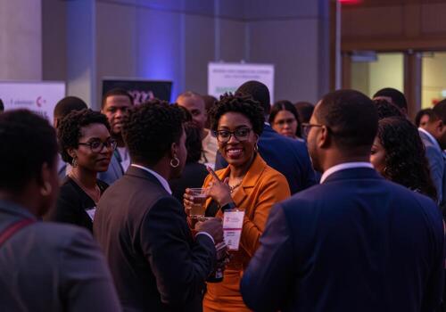 A group of people at an event talking to each other photo