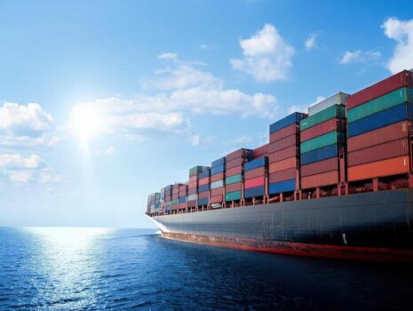 Massive container ship navigates vast ocean under bright sunny sky, symbolizing global trade and logistics. photo