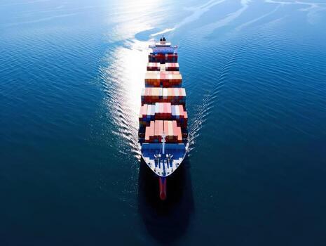 Massive container ship navigates vast ocean waters under brilliant sun, symbolizing global trade and logistics in motion photo