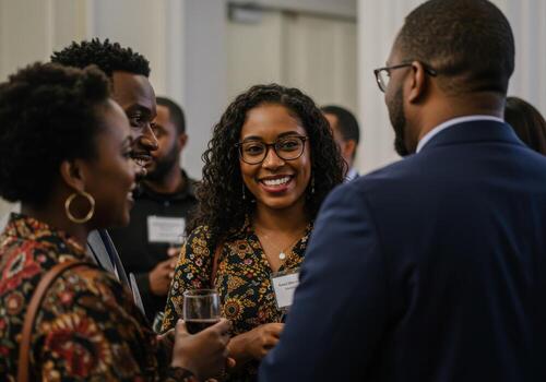 Diverse professionals connect and smile at a vibrant networking event, fostering collaboration and community growth in a modern setting. photo