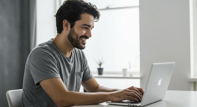 Joyful man enthusiastically typing on laptop in a bright, modern workspace, celebrating success and productivity photo