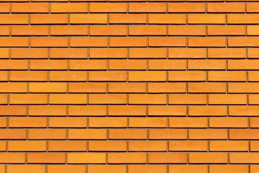 Close up view of orange brick fence with clean horizontal lines and neat geometric pattern. Smooth texture, ideal for use as background, construction material concept, architectural design element photo