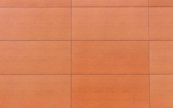 Brown wooden wall paneling with visible screws and geometric rectangular pattern. Modern architectural cladding texture suitable for construction, design backgrounds, architectural details photo