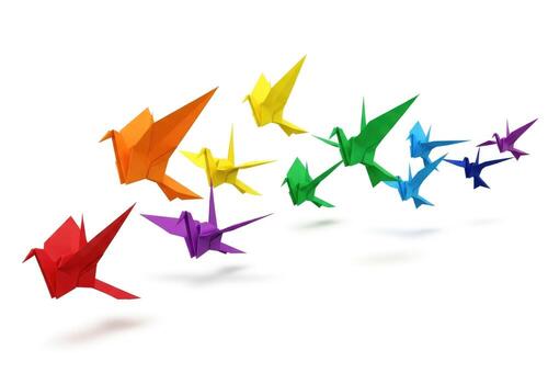 Colorful origami cranes arranged in a rainbow gradient isolated on white background photo
