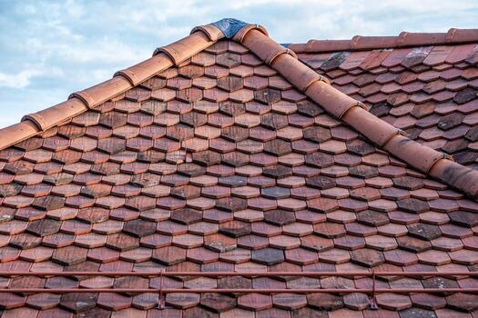 Traditional roof tiles arranged in a hexagonal pattern, showcasing durability and protection, with a beautiful sky backdrop, emphasizing architectural craftsmanship and design photo