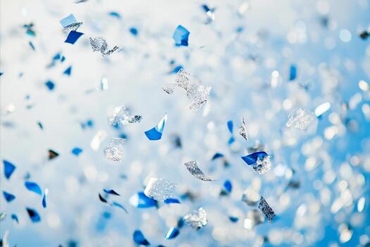 Floating Blue and Silver Confetti Against a Soft, Bokeh-Filled B photo