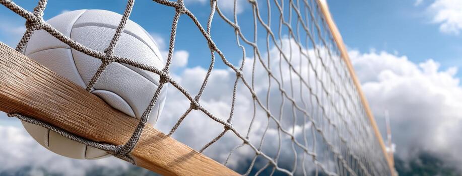 Volleyball resting on the net against a backdrop of beautiful clouds and clear blue sky during daylight photo