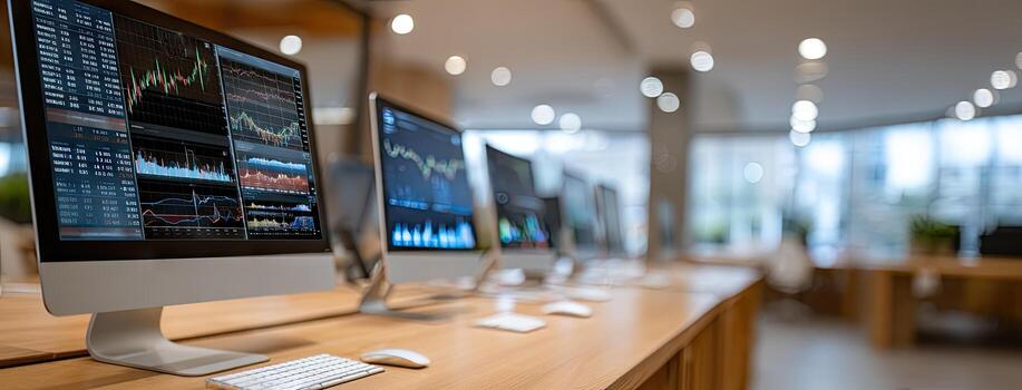 Busy trading room with multiple screens displaying market data and financial charts during a weekday morning photo