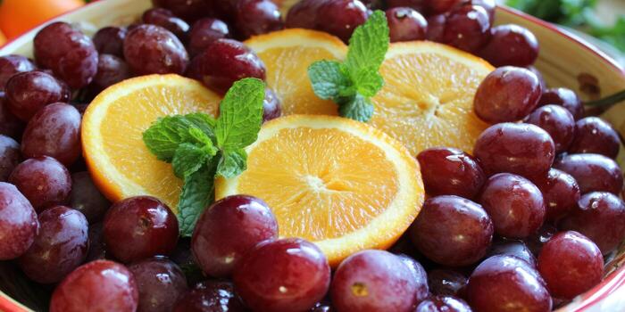 Fresh fruit platter featuring grapes and orange slices with mint garnish photo