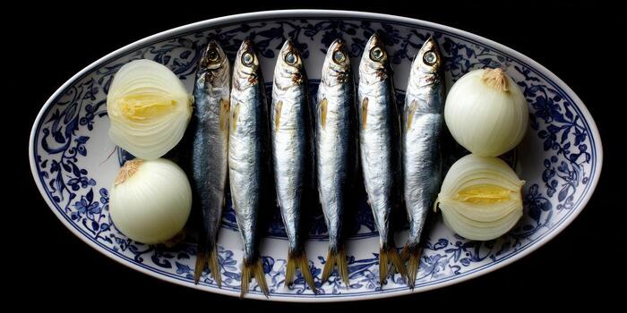 Freshly prepared fish and onions on decorative serving platter overhead view photo