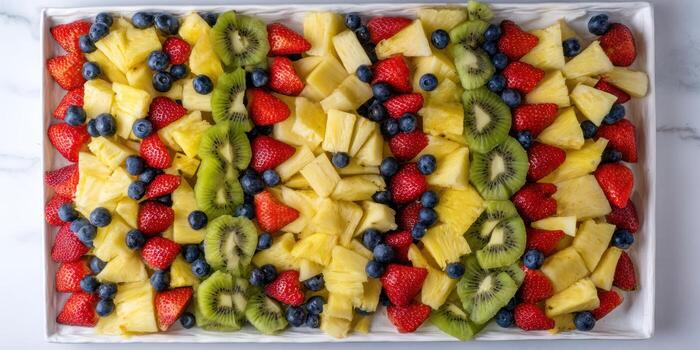 A platter of fruit arranged in a square shape photo
