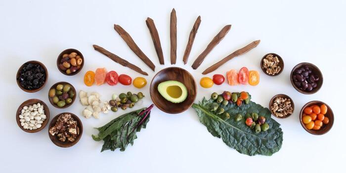 Assortment of fresh ingredients arranged in circular pattern on white surface photo
