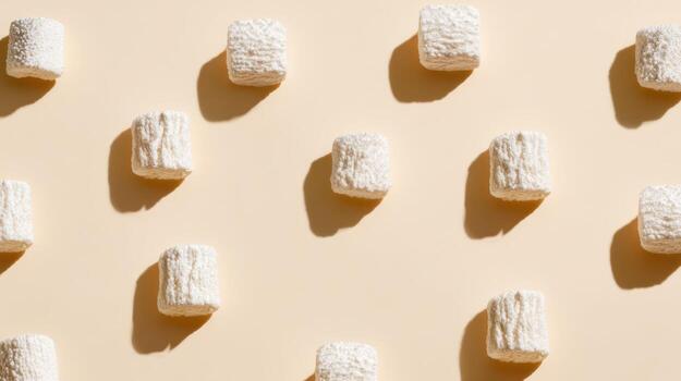 Overhead shot of white textured marshmallows on a beige background photo