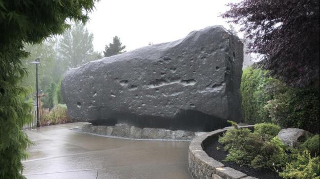 Large stone structure in a park setting under overcast conditions photo