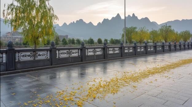 Scenic view of a bridge with yellow leaves and distant mountains photo