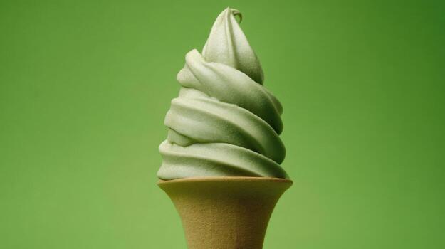 Green tea soft serve ice cream cone on green background dessert - photo