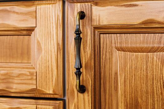 Close up view of wooden kitchen cabinets with elegant handles and detailed grain patterns photo