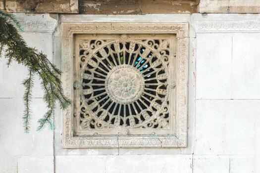 Carved stone window design with intricate patterns in historical stone architecture photo