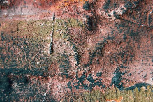 Colors blend on textured surface creating an abstract design in a weathered setting photo