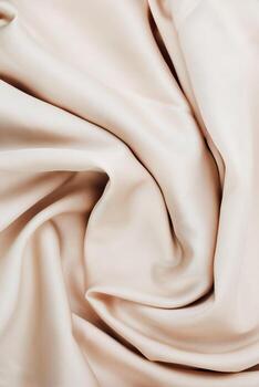 Soft beige fabric with flowing texture suitable for various design projects and crafts photo