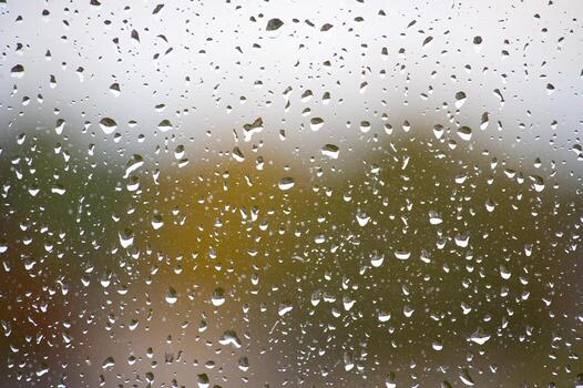 Raindrops on a window creating a beautiful, natural, and calming effect photo