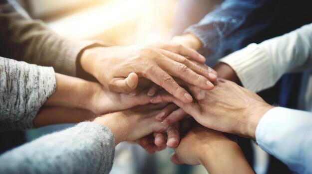 Hands stacked together symbolizing unity teamwork and cooperation photo