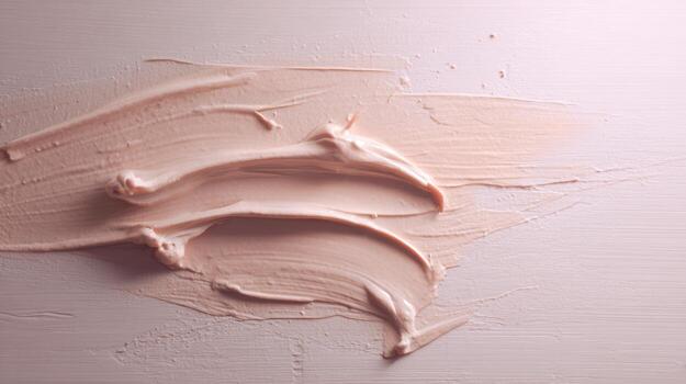 Cosmetic cream strokes on surface abstract beauty background photo