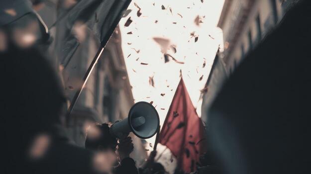 People with flags and megaphone in a rally with sunlight and confetti photo