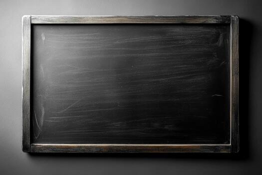 A blank blackboard with a wooden frame awaits new ideas, perfect for teaching, note-taking, or artistic expression photo