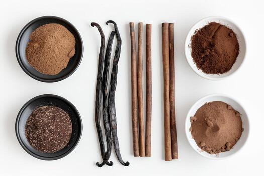 Various spices like cocoa powder, ground cinnamon, and fresh vanilla beans are displayed in small bowls and sticks, showcasing their rich textures photo