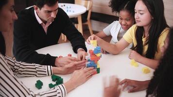 grupo do multirracial alunos e professores jogando Diversão matemático enigma jogos em mesas junto, criativamente Aprendendo dentro primário aula, crianças desafio para sabedoria às elementar internacional escola. video