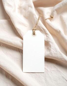 Blank White Tag on Soft Beige Fabric Background.,,,, photo