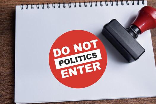 Concept of Do not enter politics a red round sign write on book isolated on Wooden Table. photo