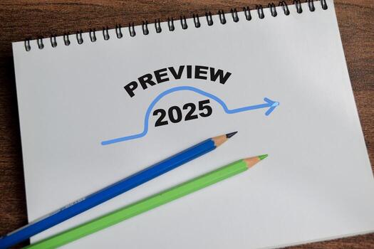Concept of Preview 2025 write on book isolated on Wooden Table. photo